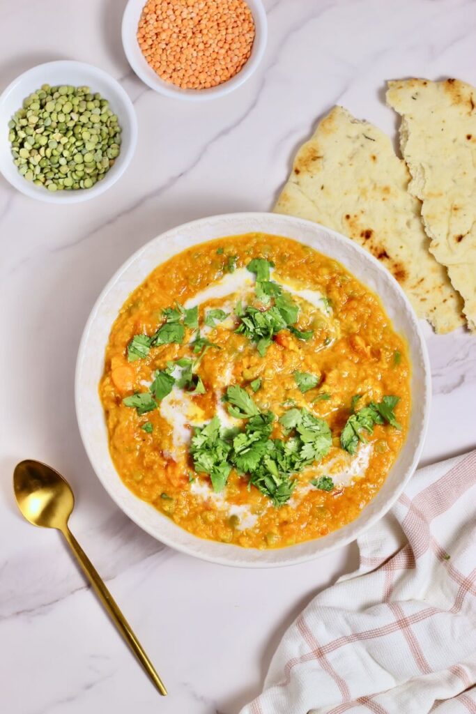 Golden Curry Lentil Dry Soup Mix final product in bowl and dry lentils and naan in background