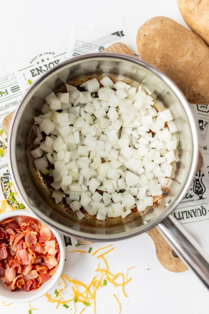 Chopped onions in a cooking pot.