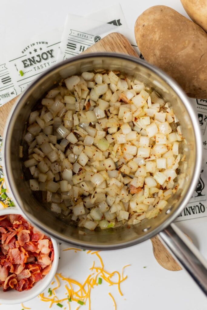 Chopped onions and bacon in pot