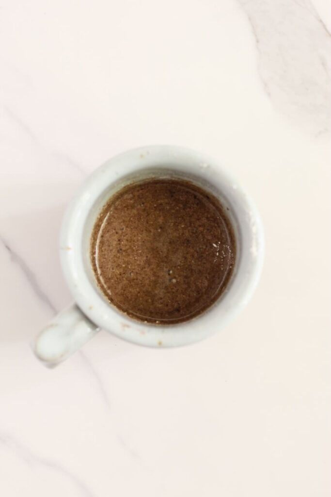 Oreo protein mug cake ingredients mixed in white mug before cooking
