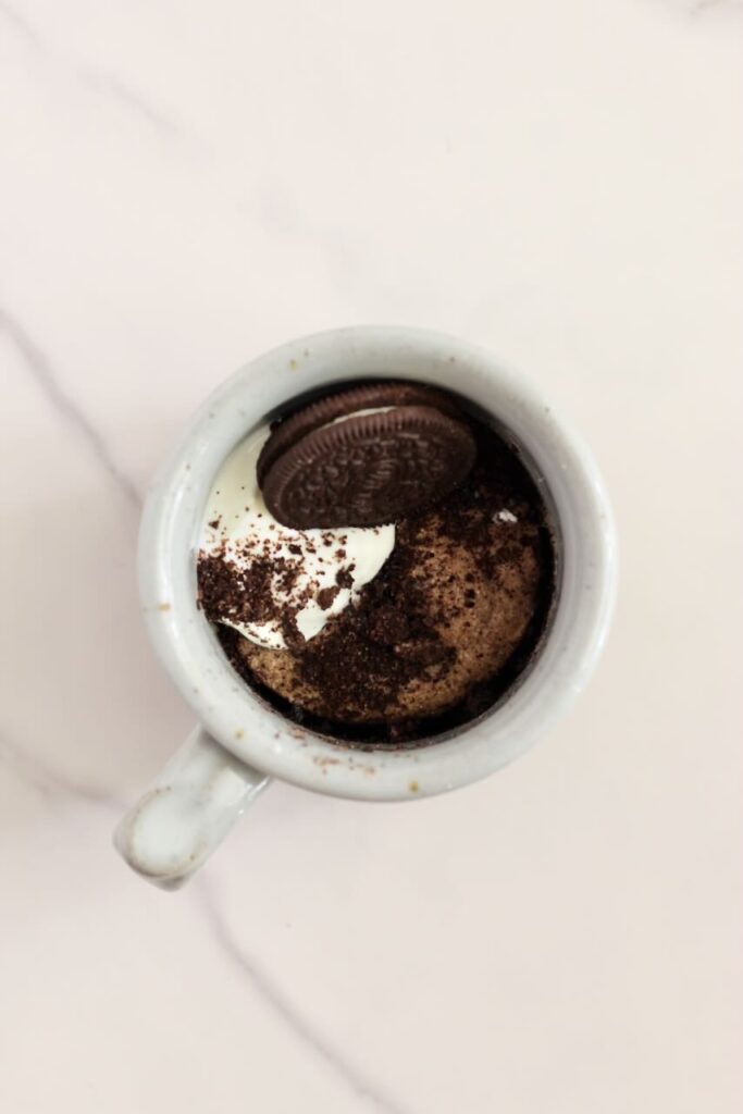 Oreo protein mug cake topped with oreo and yogurt