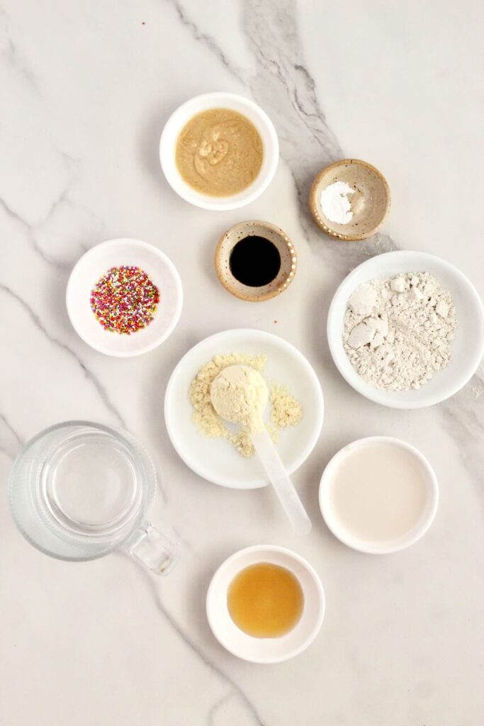 Ingredients for mug cake in separate white bowls