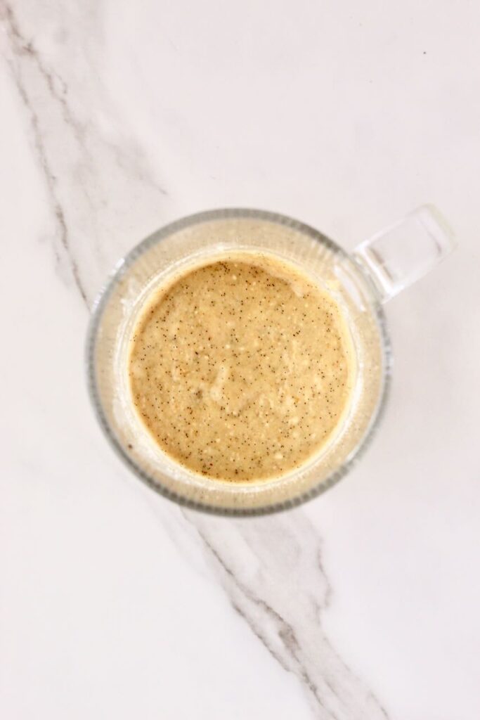 Ingredients for mug cake mixed into clear mug before cooking