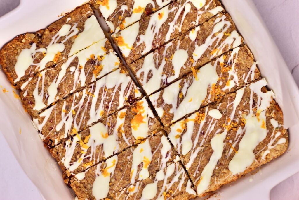 Cranberry Orange Energy Bars with white chocolate drizzle and orange zest