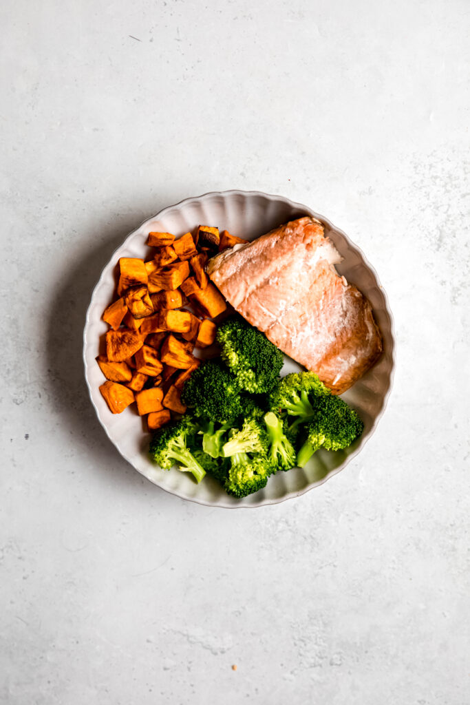 sweet potatoes, fish, and broccoli in white bowl