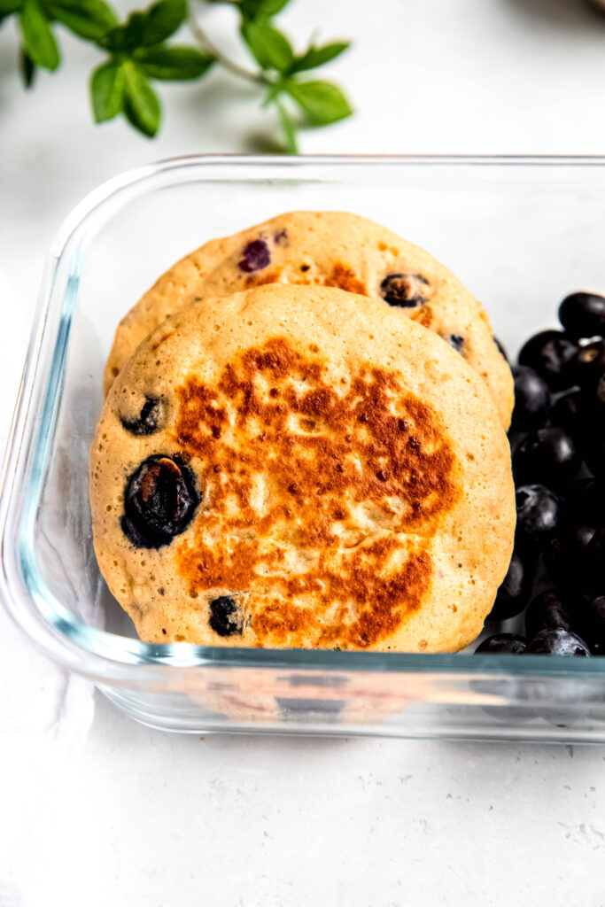 Protein pancakes in meal prep container with blueberries