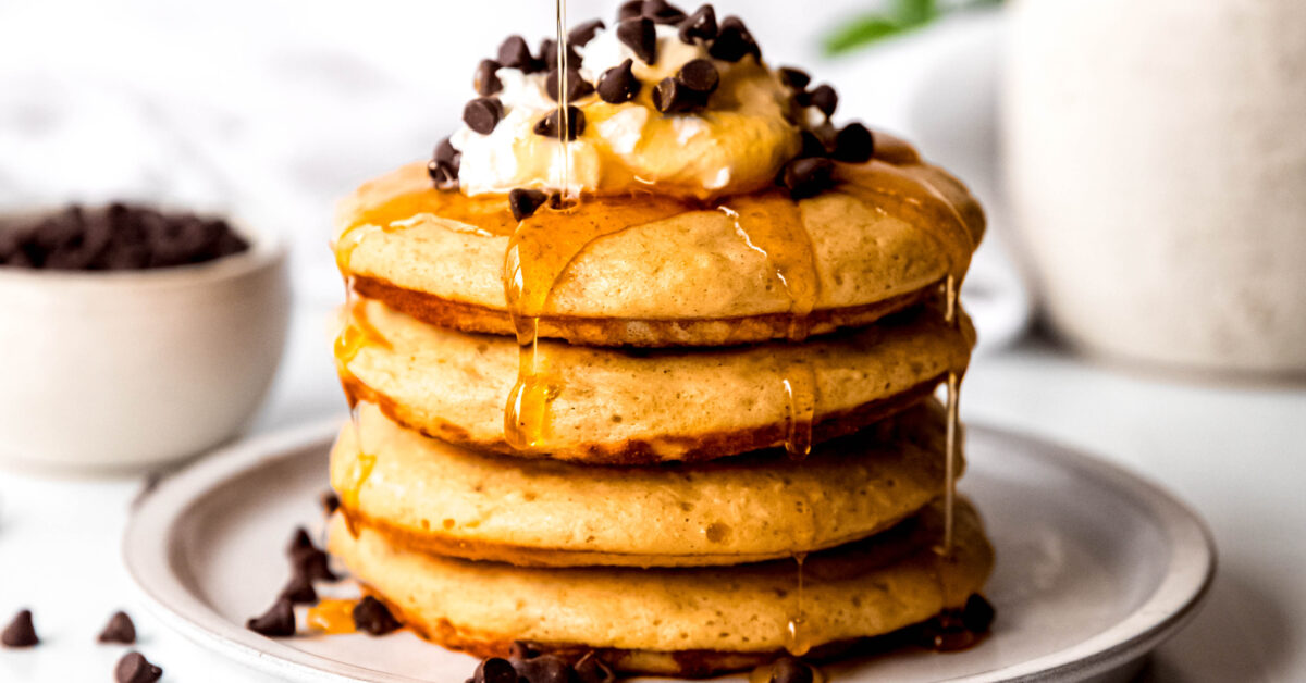 Protein pancakes stacked being drizzled with syrup