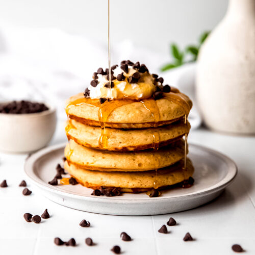 Protein pancakes stacked being drizzled with syrup