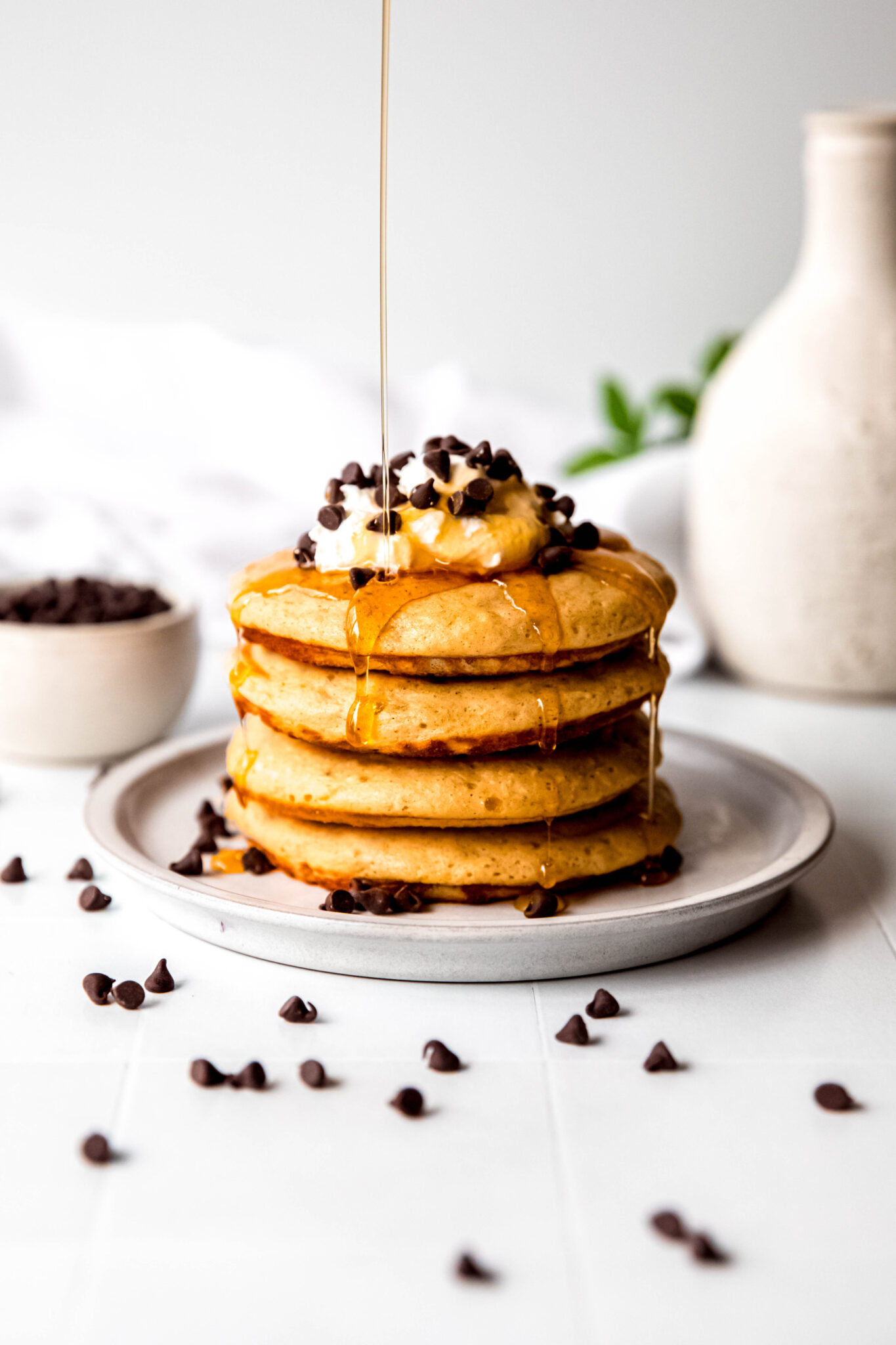 Protein pancakes stacked being drizzled with syrup