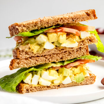 Salad sandwich on white plate