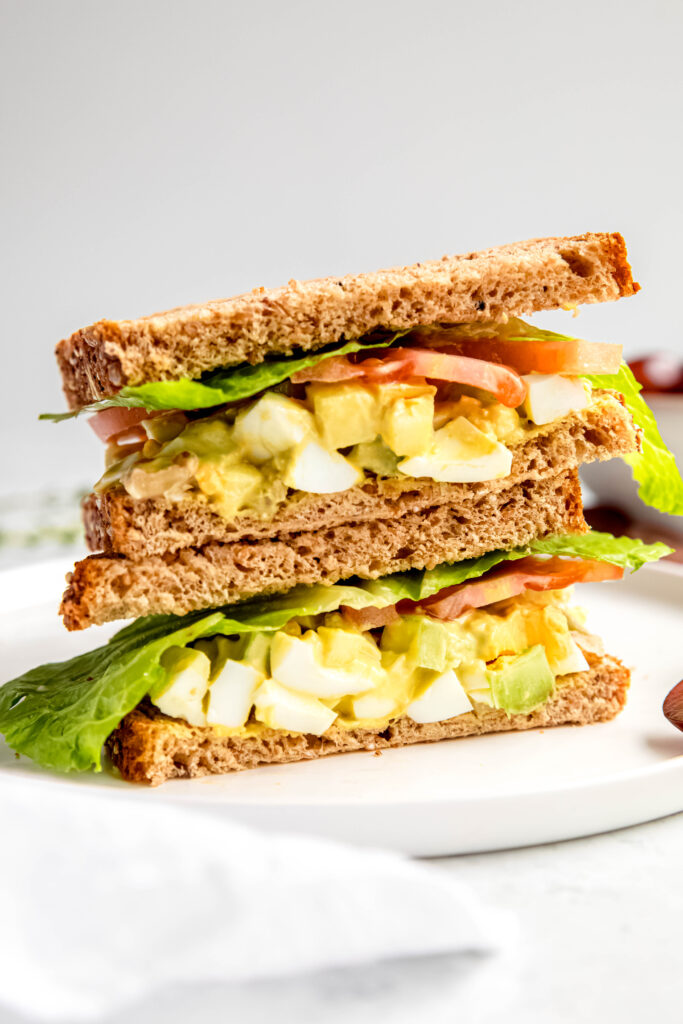 Salad sandwich on white plate