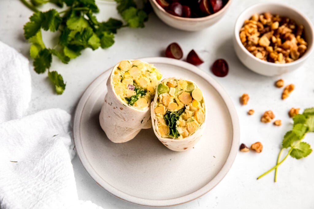 Chickpea salad wrapped in tortilla on plate