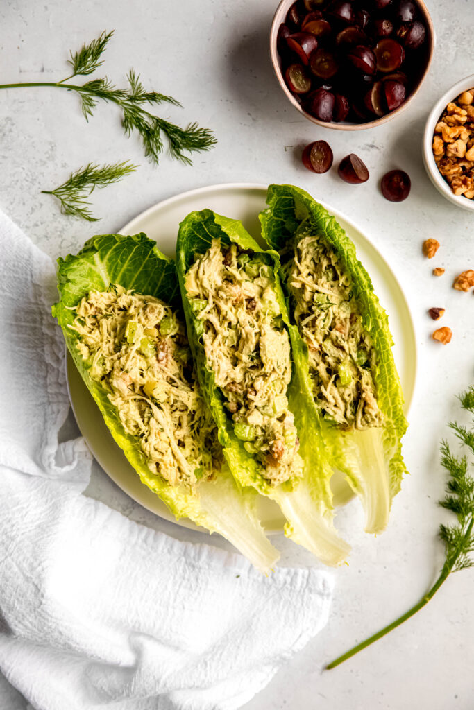 Chicken salad in lettuce leafs on white plate