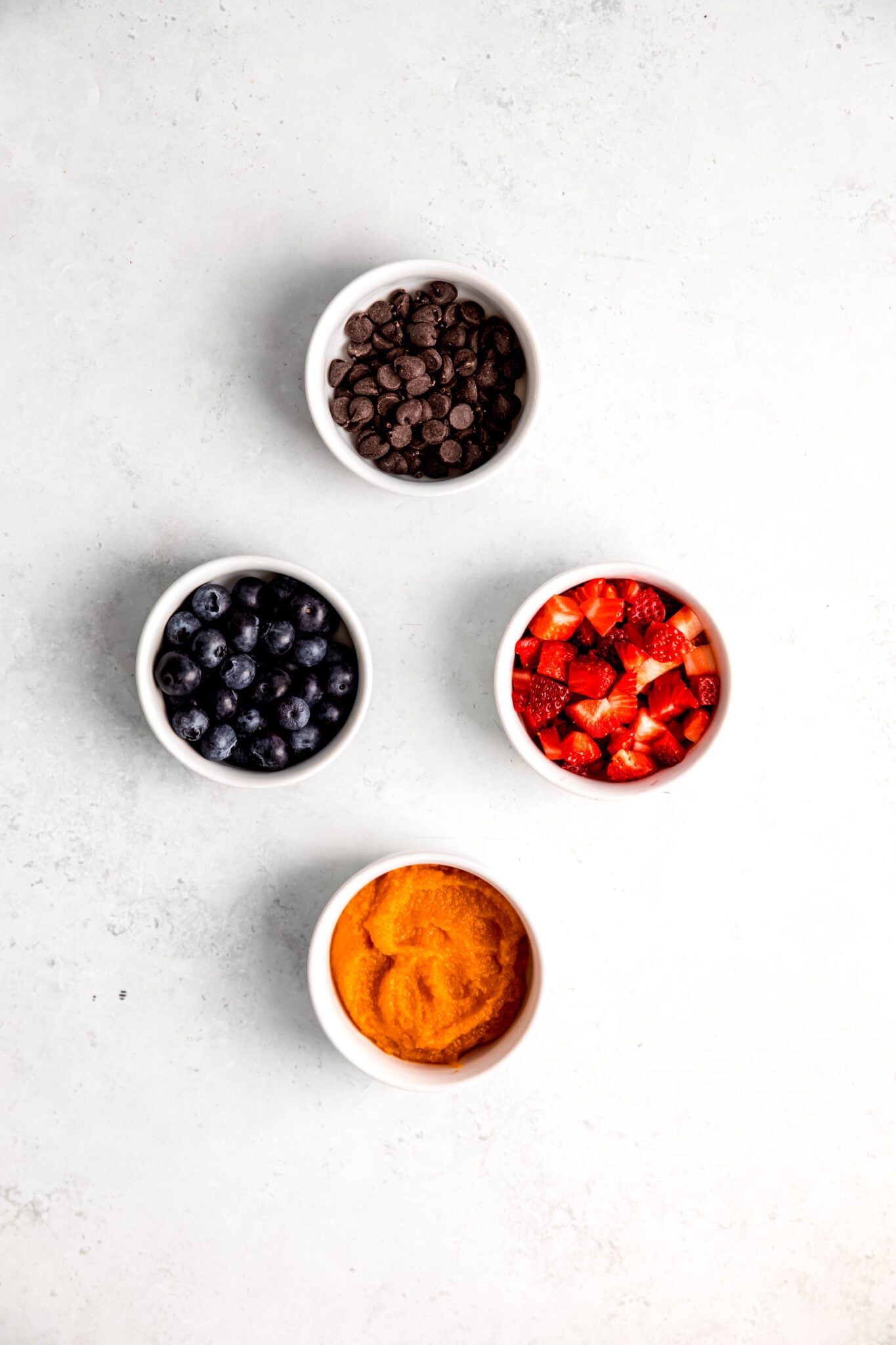 Toppings of your choice in white bowls