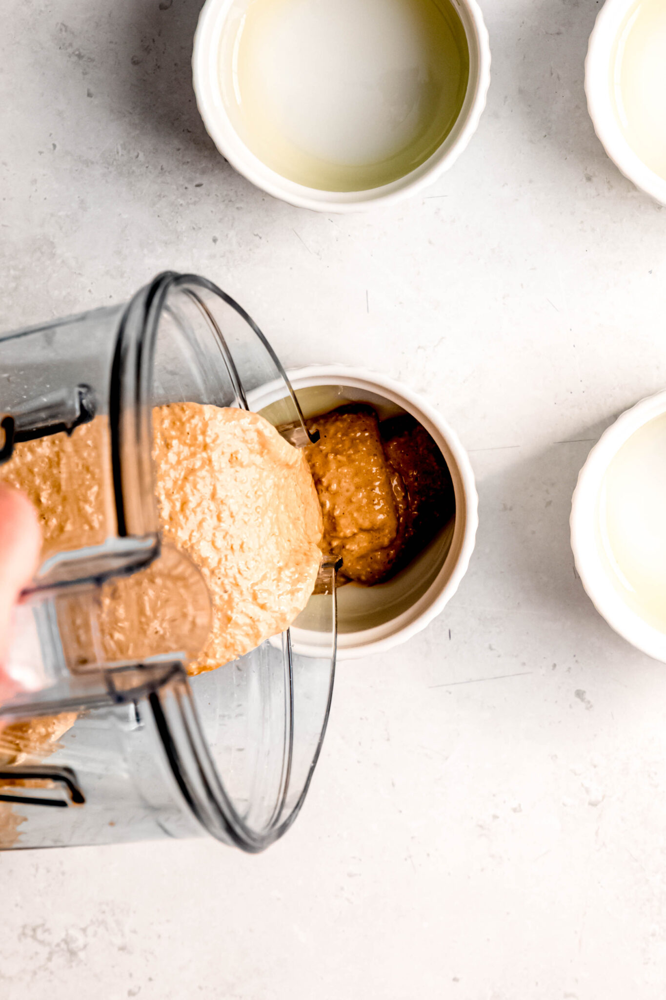 Blended mixture being poured into ramekin