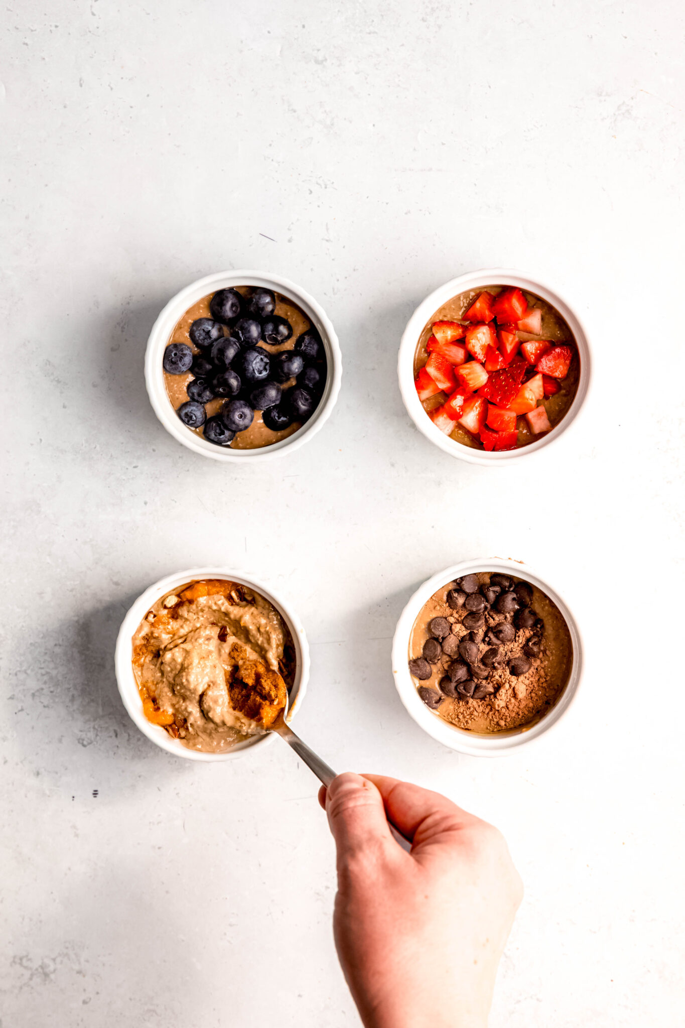 Adding toppings of choice to oats mixture