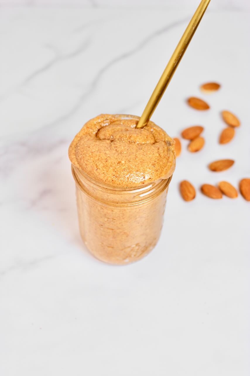 Customizable Nut Butter in jar with almonds in background