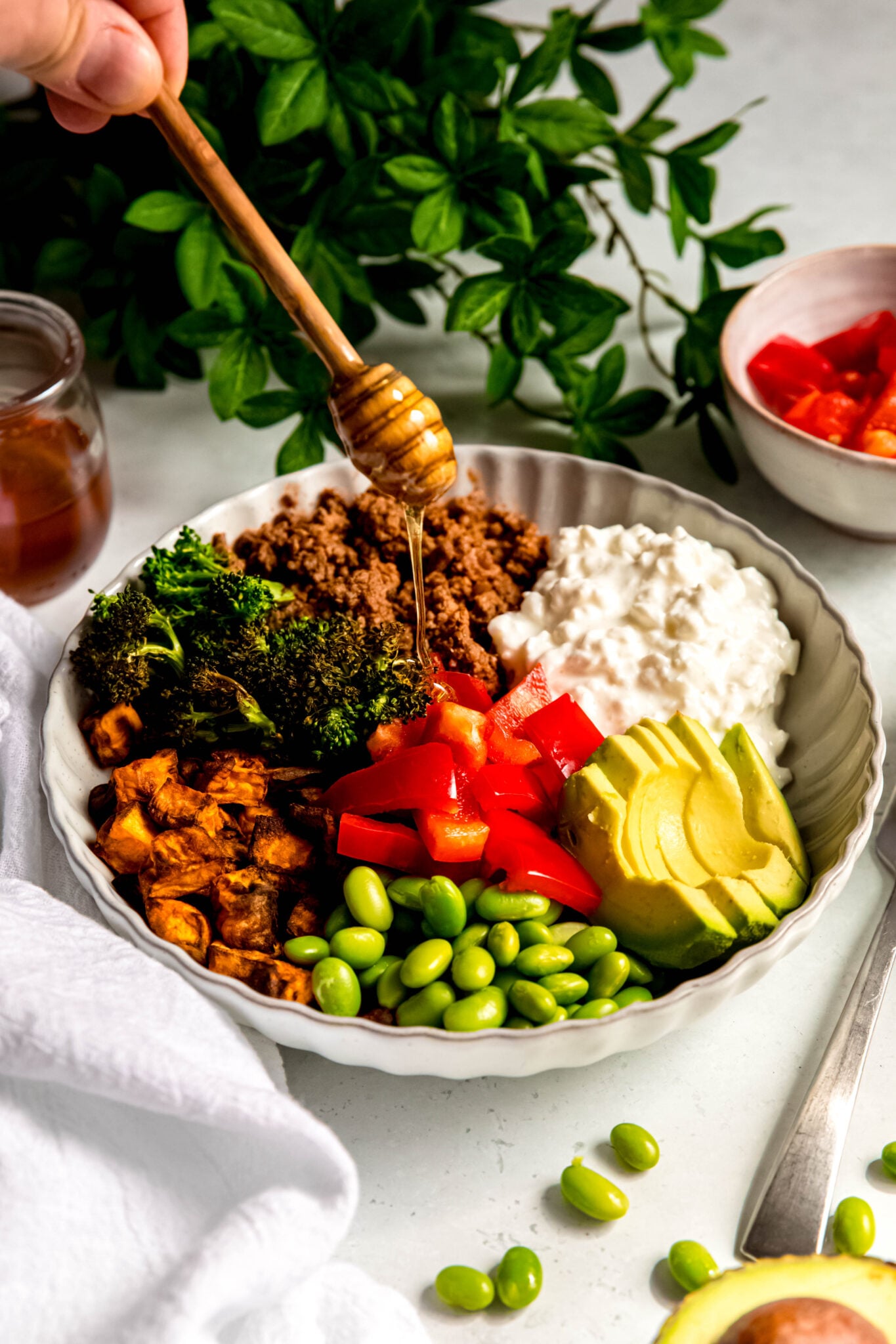 Drizzling honey on beef bowl