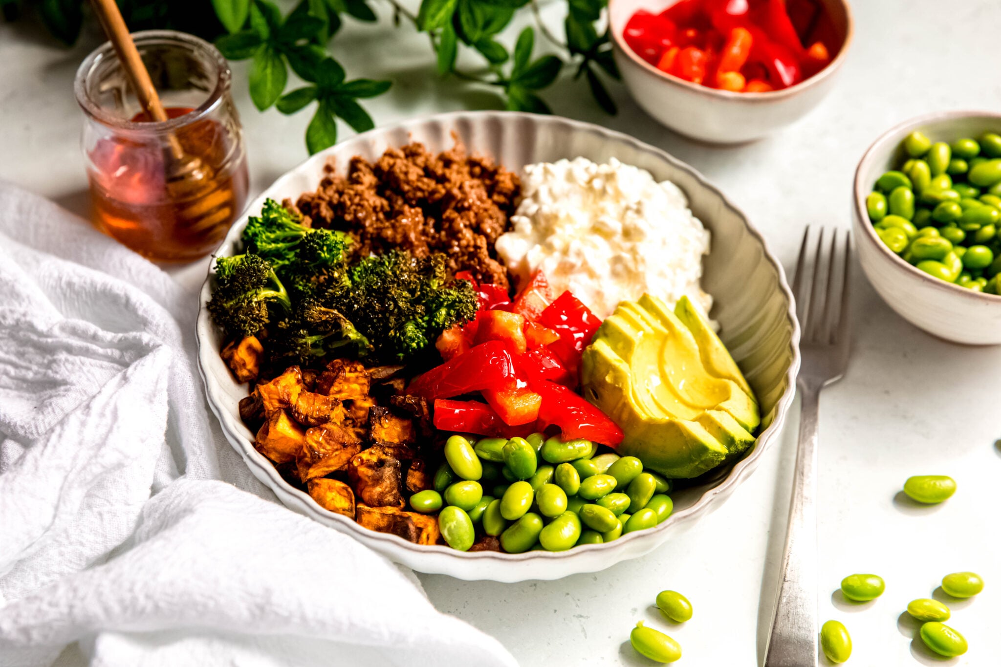 Hot Honey Ground Beef Bowls with honey in background