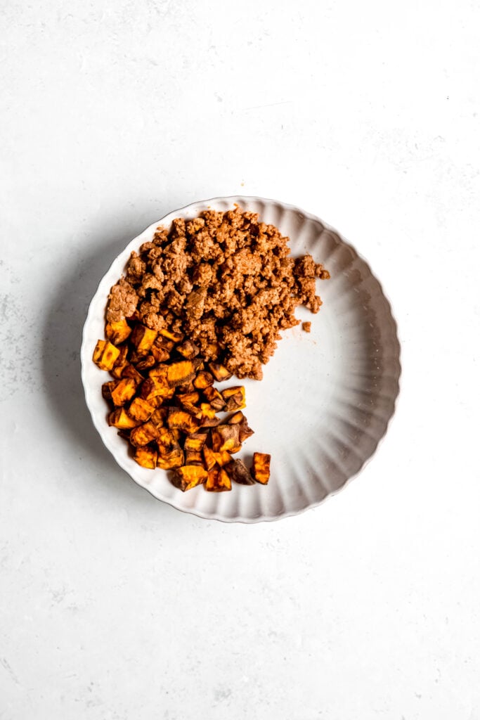 Ground beef and sweet potato on white plate