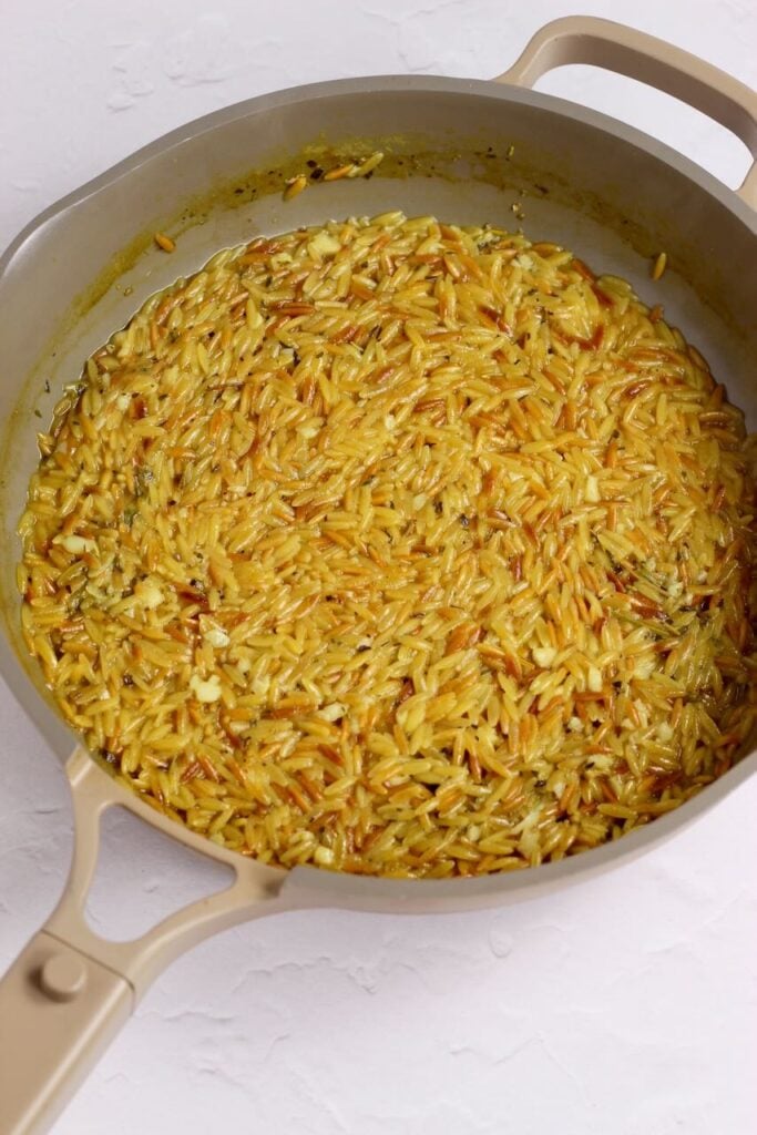 Orzo in skillet golden brown