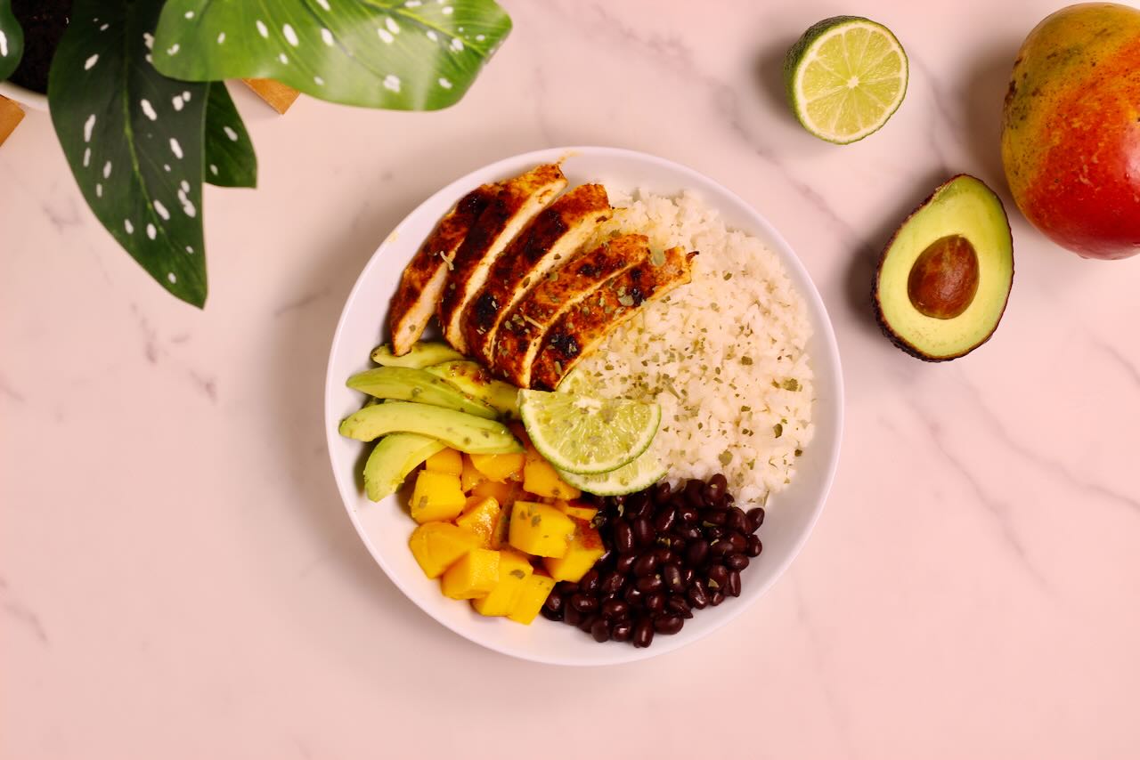 Mango Coconut Tropical Rice Bowl with avocado, lime, and mango on side